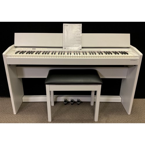 35 - A Roland Digital Piano, model F-140R, in white, with conforming piano stool.