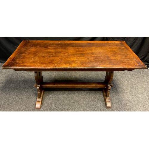 39 - A mid 20th century oak trestle dining table, 76cm high x 152.5cm long x 74.5cm wide.