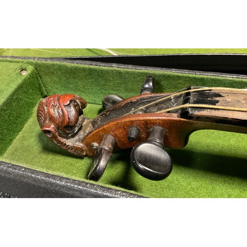 66 - A full size violin, the peg-box scroll carved as the head of a lion, in the style of Jacobus Stainer... 