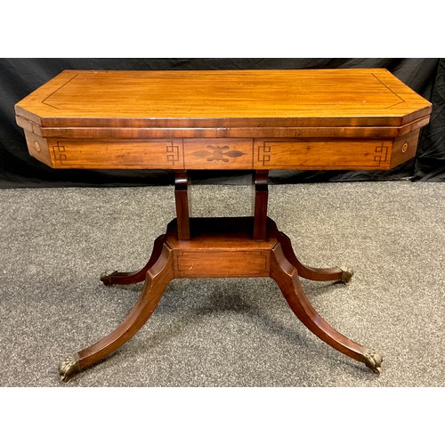 71 - A 19th century mahogany games table, canted rectangular fold-over top, with red baize interior, sabr... 