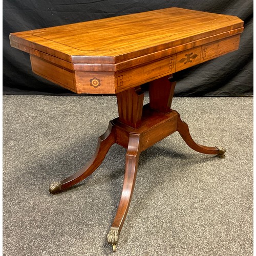 71 - A 19th century mahogany games table, canted rectangular fold-over top, with red baize interior, sabr... 