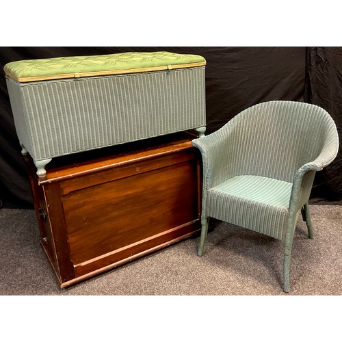 74 - A Lloyd Loom ‘Lusty’ tub armchair, and a matching blanket chest;  a stained pine blanket chest, (3).