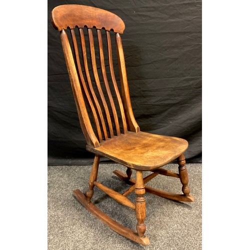 77 - An early 20th century elm and beech lath-back rocking chair, 101cm high x  44cm wide x 55cm deep.