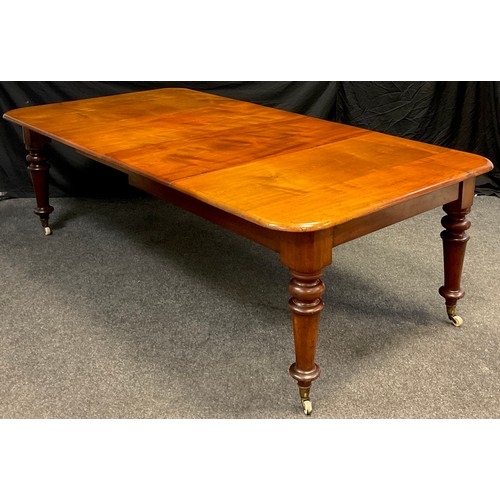 79 - A Victorian mahogany extending dining table, the rounded rectangular top, with two additional leaves... 