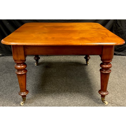 79 - A Victorian mahogany extending dining table, the rounded rectangular top, with two additional leaves... 