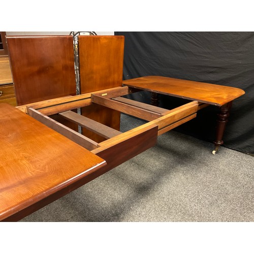 79 - A Victorian mahogany extending dining table, the rounded rectangular top, with two additional leaves... 