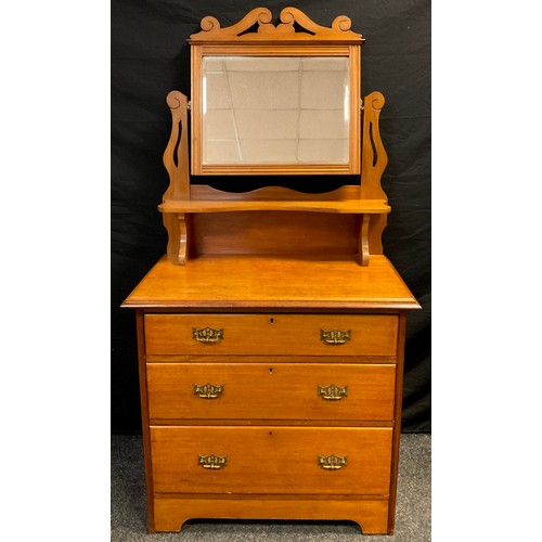 105 - An early 20th century mahogany dressing chest, rectangular bevelled plate over single shelf, and thr... 