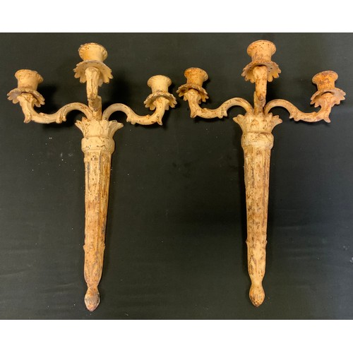 142 - A pair of ornate cast iron candelabras, painted white,45cm long