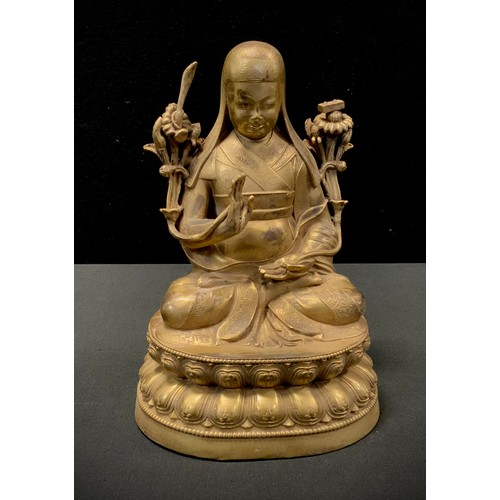 175 - A gilt bronzed metal figure, Contemplating Buddhistic deity, in the lotus position, 23.5cm high.