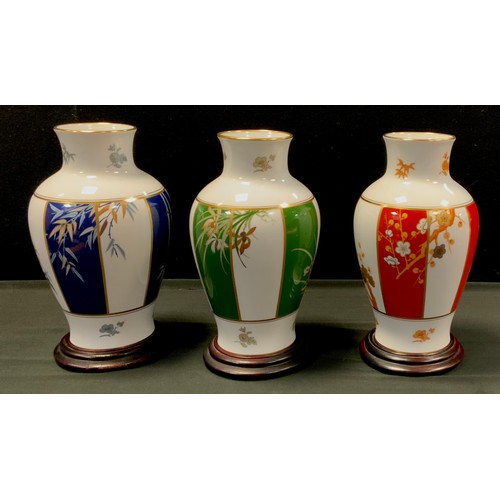 252 - A set of three limited edition Franklin Mint vases; 'The vase of Noble Plum Blossom', 'The vase of t... 