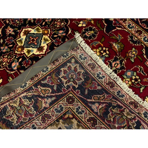 279 - A Central Persian Kashan runner carpet, hand-knotted in rich red, blue, and deep indigo, with highli... 