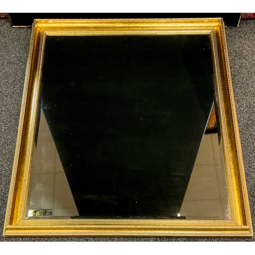 297 - A large ‘gilt’ framed wall mirror, bevelled glass, 103cm x 131.5cm overall size.