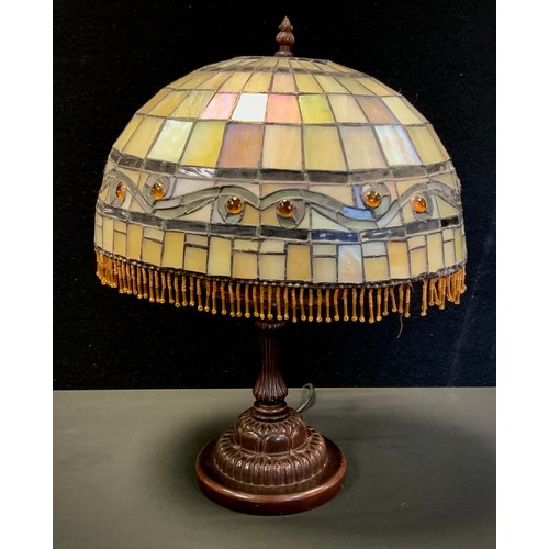 305 - A Tiffany style oval stained and leaded glass table lamp, bronze coloured lamp base, the oval shade ... 