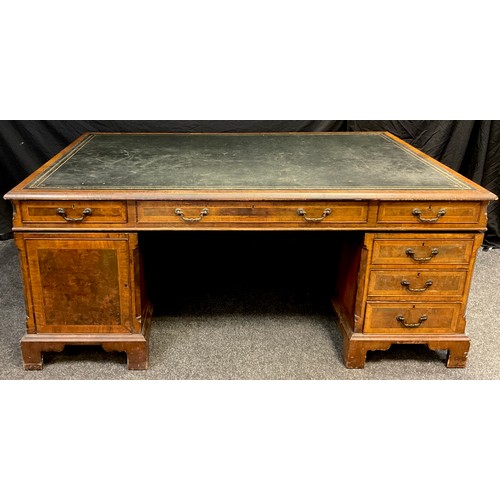 306 - A George III style mahogany and walnut veneered partner’s desk, dark green faux leather writing surf... 