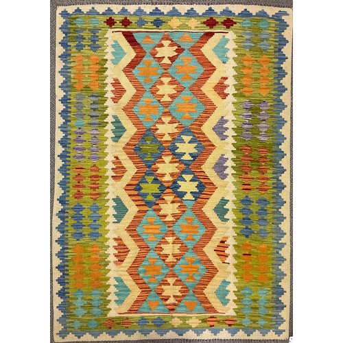 390 - A Turkish Anatolian Kilim, knotted with a geometric pattern in tones of red, blue, green, and cream,... 