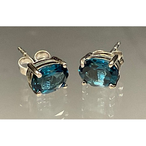 435 - A pair of London blue topaz oval stud earrings, silver mounts, 1.9g gross