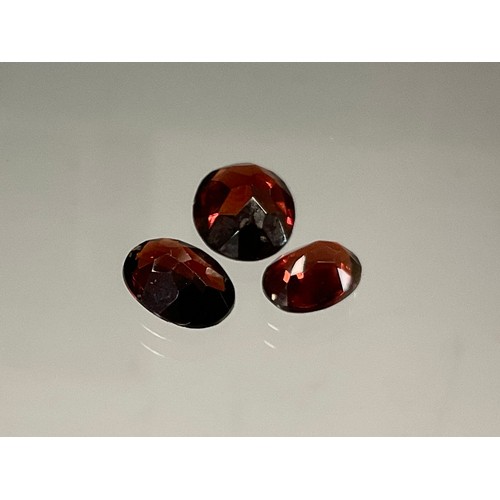 439 - Loose Gemstones - three oval cut red garnets, total stone weight 6.84ct (3)