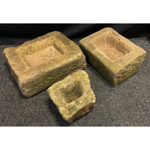 107 - Three rough hewn Derbyshire Gritstone troughs, of graduated sizes, the largest measuring 14cm high x... 