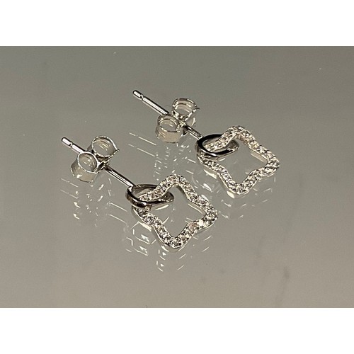 443 - A pair of square star cubic zirconia set silver earrings.