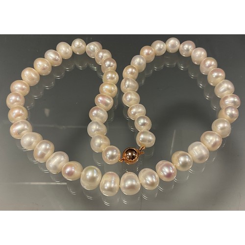 445 - A single strand of large and heavy freshwater cultured pearls, of irregular creamy white colour, lar... 