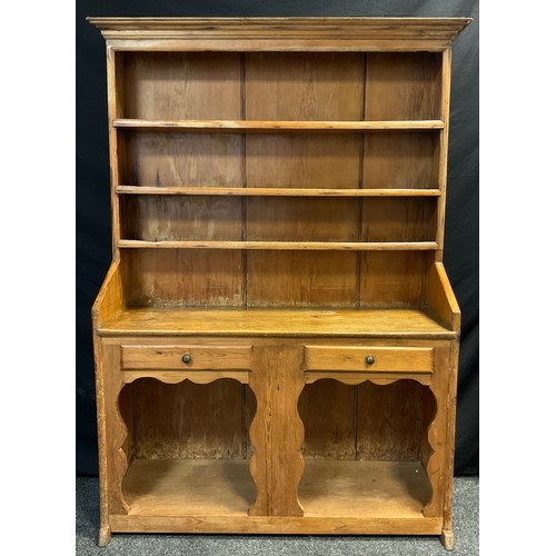 294A - A pine dresser, swept cornice to the plate-rack top, with three tiers of shelving, above a pair of d... 