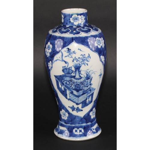 11 - A Chinese baluster vase, painted in tones of underglaze blue with table sets with censers, planters ... 