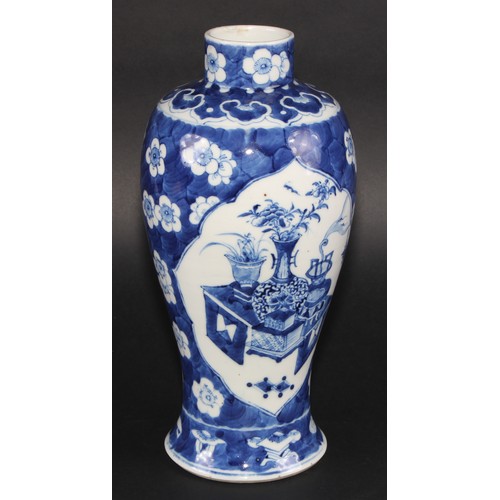 11 - A Chinese baluster vase, painted in tones of underglaze blue with table sets with censers, planters ... 