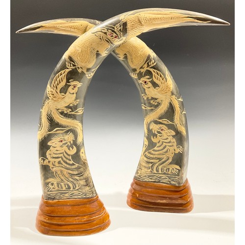 21 - A pair of carved buffalo horns, engraved in low relief with tigers, dragons and fanciful birds, step... 