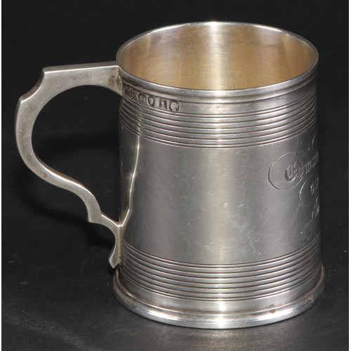 28 - A Victorian silver christening mug, moulded rim above two deep reeded bands, shaped scroll handle, s... 