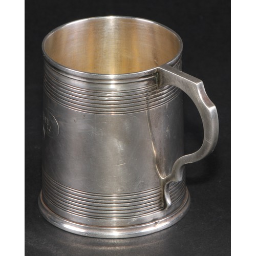28 - A Victorian silver christening mug, moulded rim above two deep reeded bands, shaped scroll handle, s... 