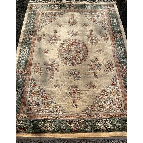 315A - A Chinese deep pile woollen carpet, woven in tones of cream, pink, beige and green, 372cm x 278cm.