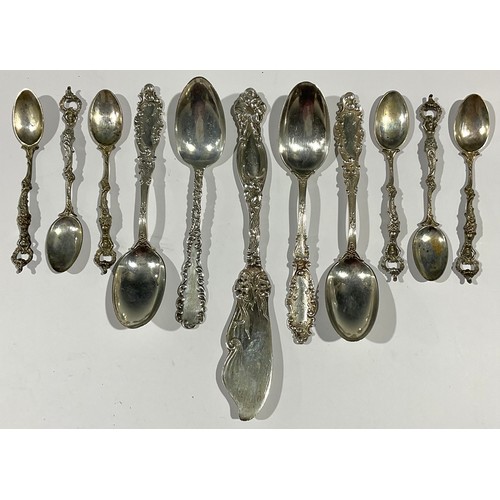 68 - A set of six continental silver teaspoons, the hafts as semi-nude mermaids, open terminals, marked K... 