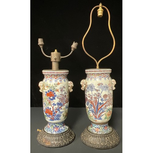 71 - A pair of early 19th century Chinese vases, converted to lamps, on carved wooden bases (vase bases a... 