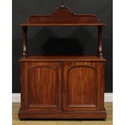 104 - A Victorian mahogany serving buffet, shaped cresting, pierced and carved end supports, the base with... 