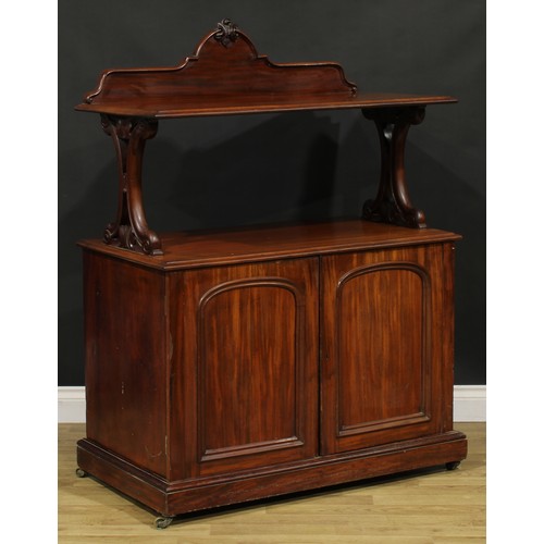 104 - A Victorian mahogany serving buffet, shaped cresting, pierced and carved end supports, the base with... 