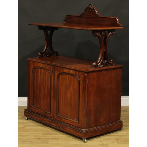 104 - A Victorian mahogany serving buffet, shaped cresting, pierced and carved end supports, the base with... 