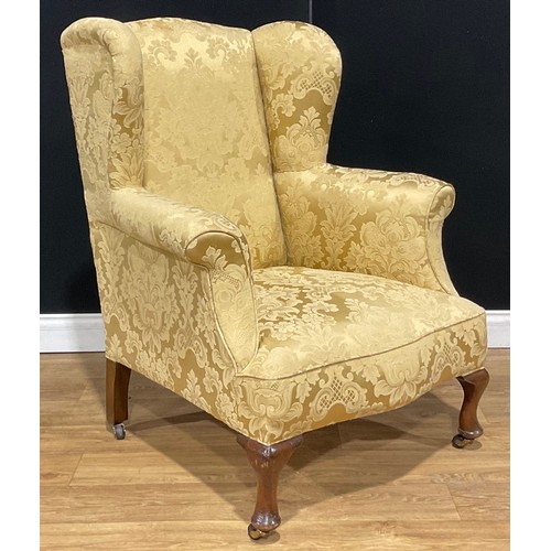 114 - A George II Revival wing chair, 105cm high, 83cm wide, the seat 43.5cm wide and 56cm deep