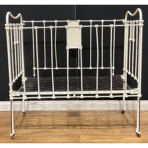 416 - A late Victorian painted iron cot or crib, 119.5cm high, 122cm long, 63.5cm wide