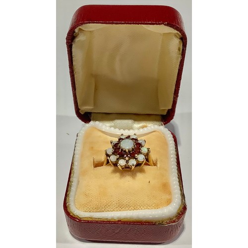 671 - A 9ct gold opal and garnet flower head cluster ring, size N/O, London 1973, 2.9g