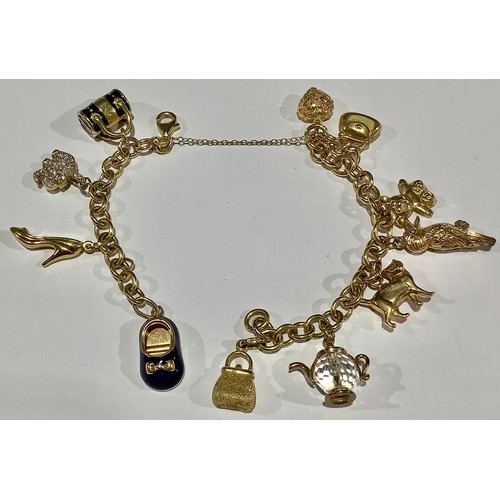 707 - A 9ct gold charm bracelet, assorted 9ct gold charms, bear, heart, shoes, handbag, cat, etc, safety c... 