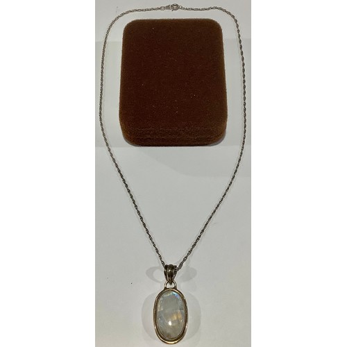 710 - A silver pendant, set with oval cabochon quartz with 'moonstone' flare, marked 925