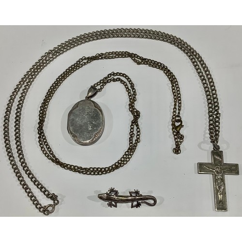 712 - A silver locket and chain, marked 925; a crucifix and chain; a lizard brooch, marked 925 (3)