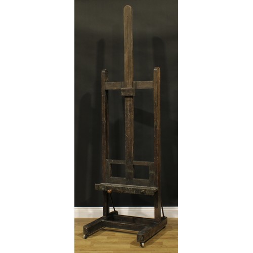 119A - A 19th century artist's studio painting easel, adjustable on a pulley system, H-shaped base, wooden ... 