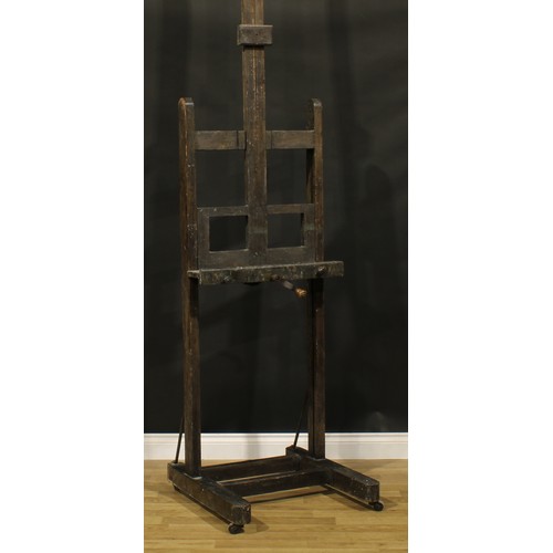 119A - A 19th century artist's studio painting easel, adjustable on a pulley system, H-shaped base, wooden ... 