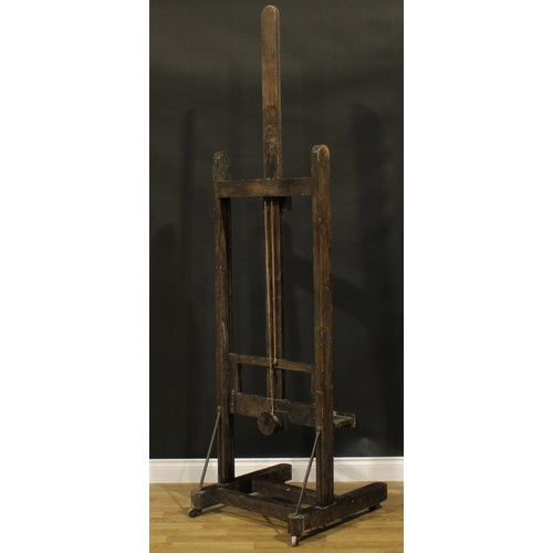 119A - A 19th century artist's studio painting easel, adjustable on a pulley system, H-shaped base, wooden ... 