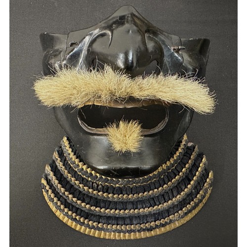 2096 - Japanese Samurai Menpo or Me no shita Facial Armour. Black laquered finish with gilt decoration and ... 