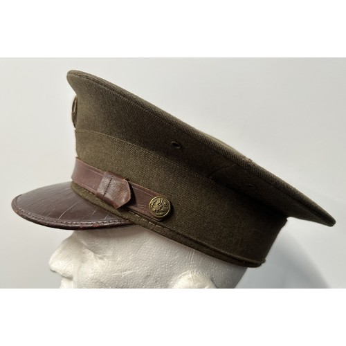 2187 - WW2 US Army Enlisted Man's Visor Cap. Complete with cap badge and chinstrap. Size 7 1/8th Named to 