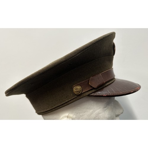 2187 - WW2 US Army Enlisted Man's Visor Cap. Complete with cap badge and chinstrap. Size 7 1/8th Named to 