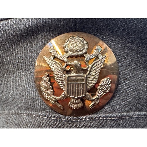 2187 - WW2 US Army Enlisted Man's Visor Cap. Complete with cap badge and chinstrap. Size 7 1/8th Named to 