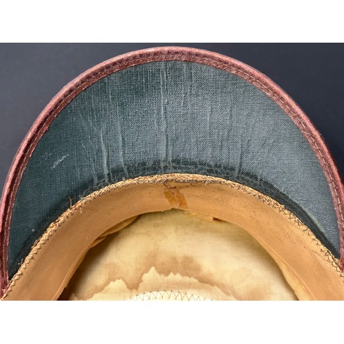 2187 - WW2 US Army Enlisted Man's Visor Cap. Complete with cap badge and chinstrap. Size 7 1/8th Named to 